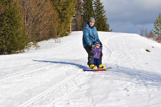 Man and child on a snowboard