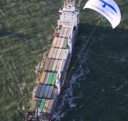 Container ship being towed by a massive power kite
