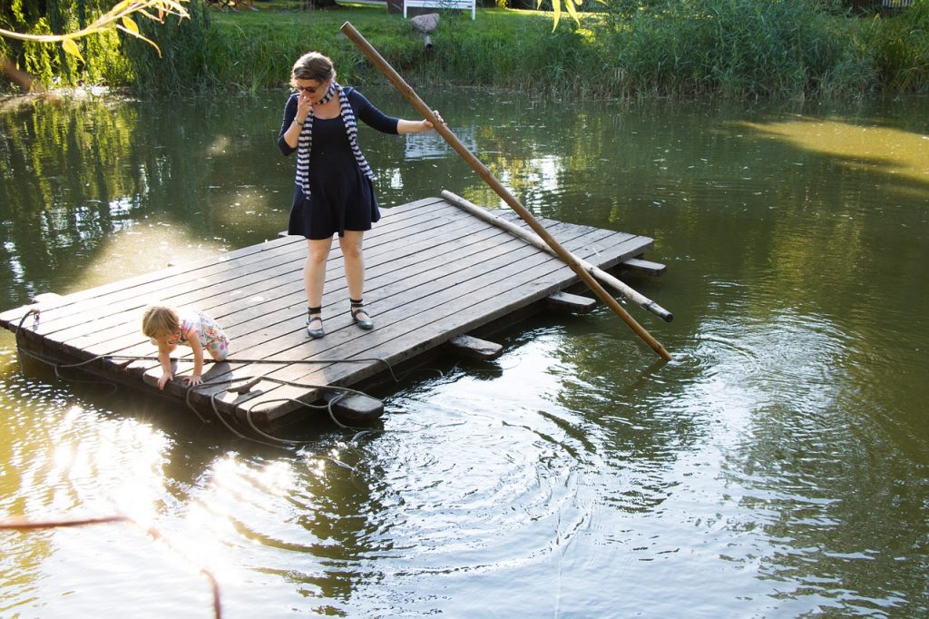 Woman with child on a wooden raft