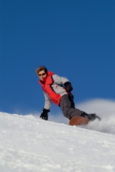 Snowboarder speeding downhill